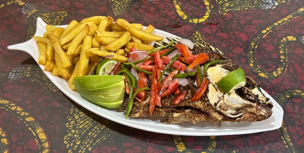 Charcoal grilled whole tilapia with potato chips, avocado and a fresh tomato and pepper salsa
